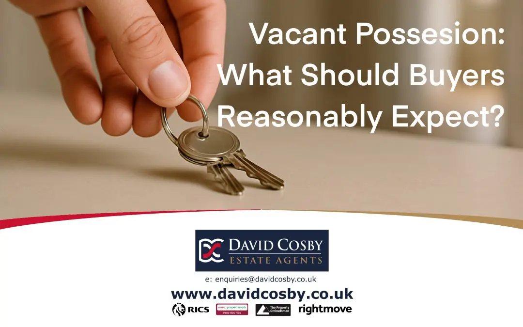A close-up of a hand placing modern house keys on a clean surface during a property handover, with a tidy interior softly blurred in the background.