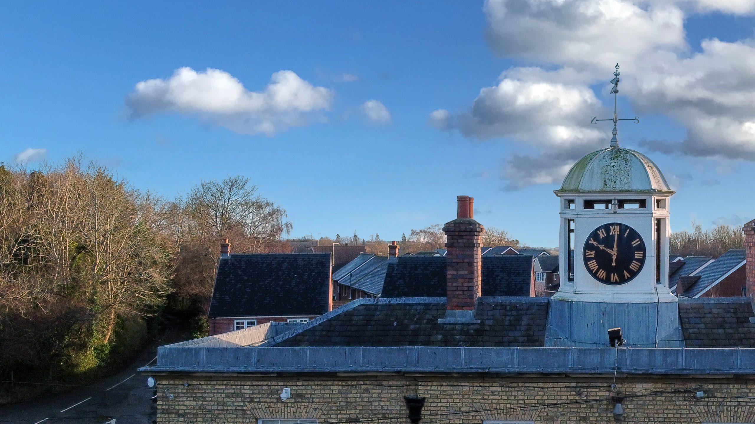 A roof level image of the East Lodge Gate House of the Royal Ordnance Depot, Weedon. Built in 1802. Showing hipped slate roof with cupola clock.